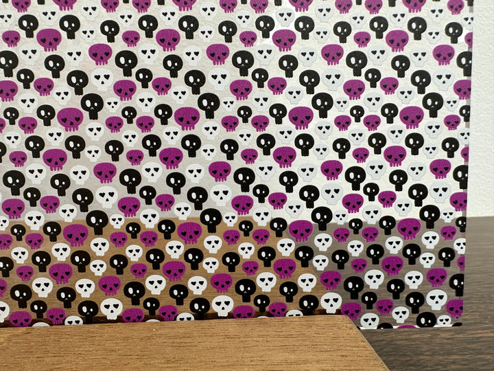 PatternPly® Scattered Purple, Black, and White Skulls