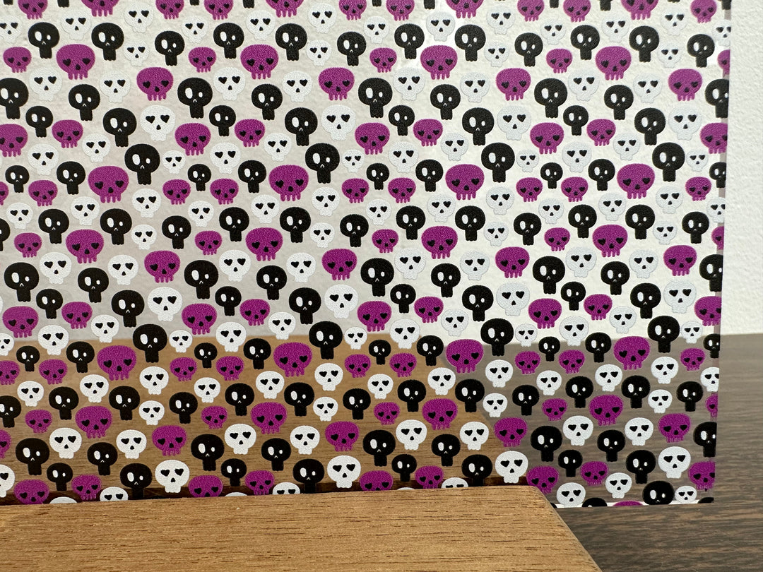 PatternPly® Scattered Purple, Black, and White Skulls