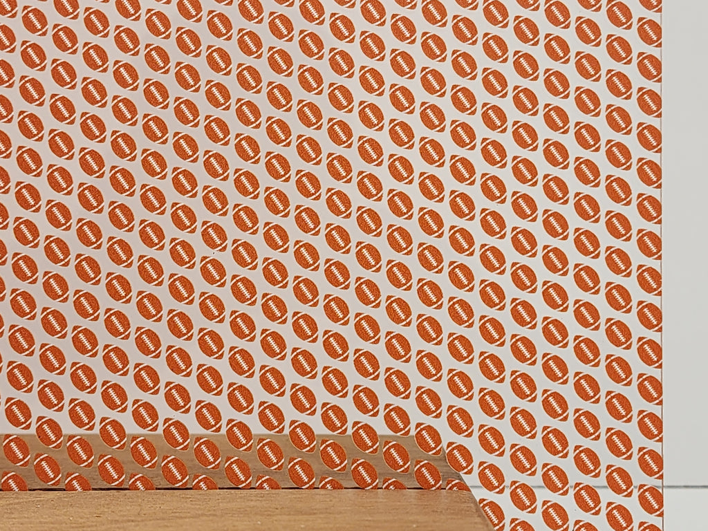 PatternPly® Scattered Orange and White Footballs sheet showing the pattern