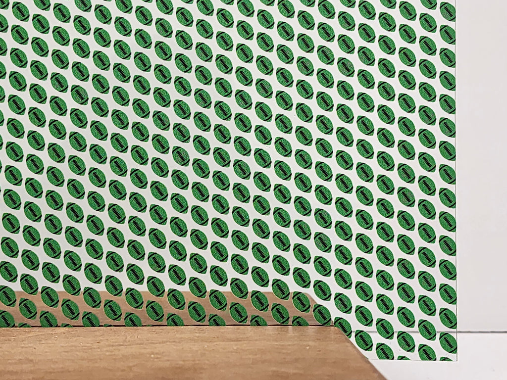 PatternPly® Scattered Green and Black Footballs sheet showing the pattern