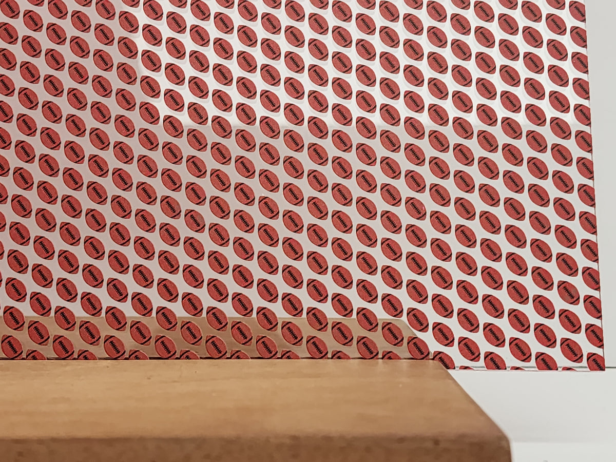 PatternPly® Scattered Red and Black Footballs sheet showing the pattern