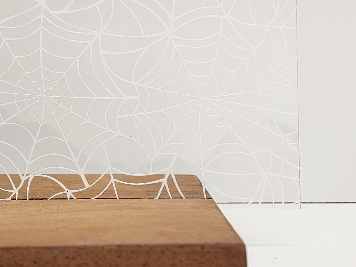 PatternPly® Scattered Large White Spiderwebs sheet showing the pattern