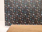 PatternPly® Full Coverage Mid Century Modern Snowflakes Black Background sheet showing the pattern