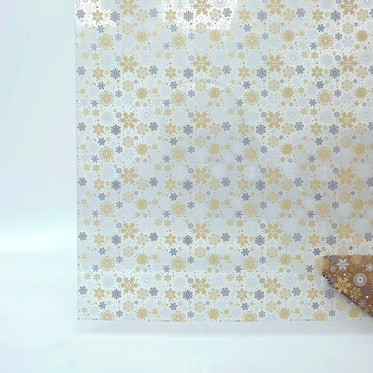 PatternPly® Scattered Gold and Silver Snowflakes sheet showing the pattern