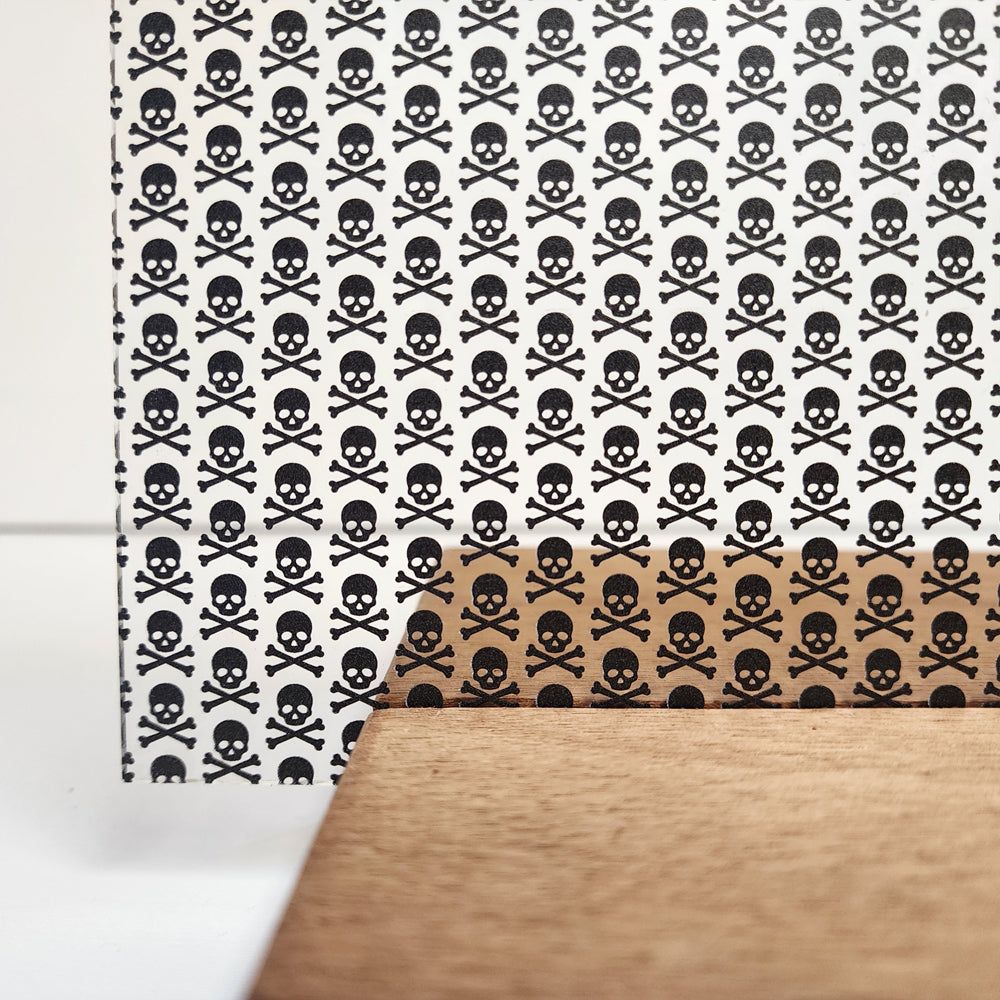 PatternPly® Scattered Black Skull and Crossbones sheet showing the pattern