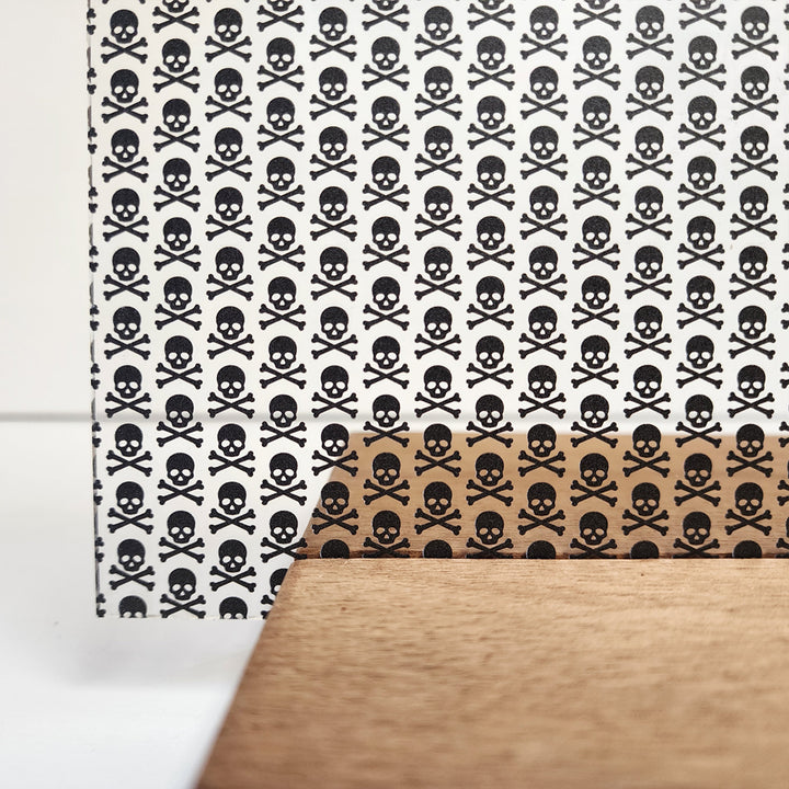 PatternPly® Scattered Black Skull and Crossbones