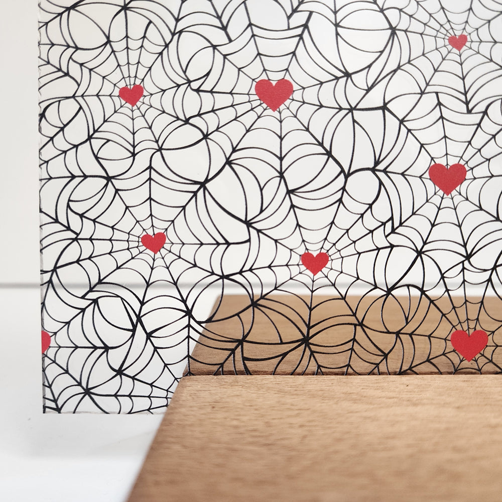 PatternPly® Scattered Black Spiderwebs with Red Hearts sheet showing the pattern