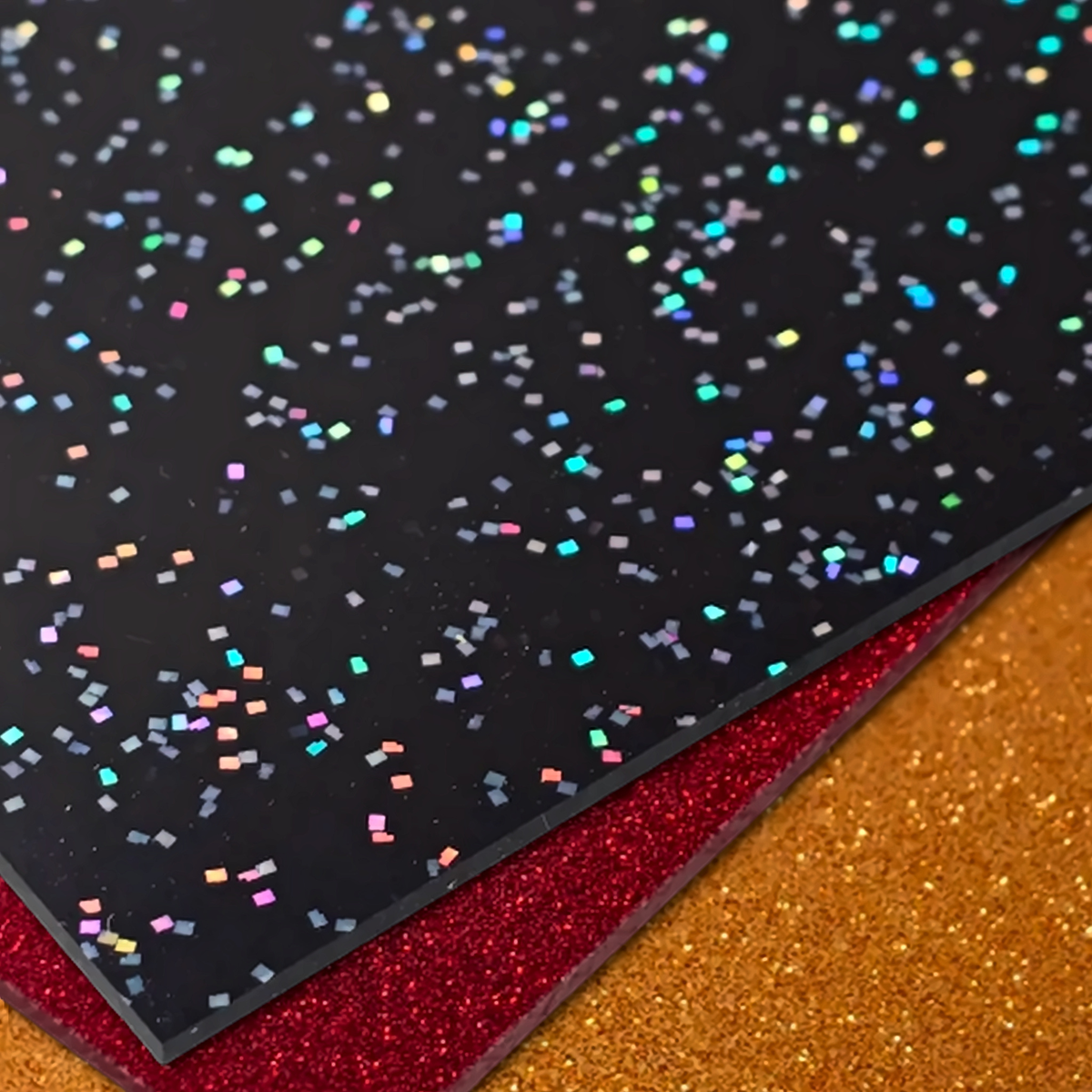 Diode Friendly Glitter Acrylic — stacked black holographic confetti, red glitter, and gold glitter sheets