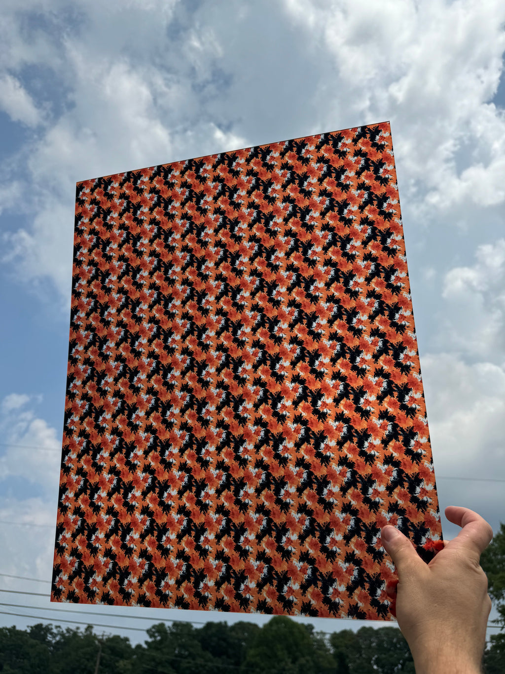 PatternPly® 19x24" Transparent Black and Orange Tie Dye Original Scale sheet showing the pattern