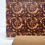 PatternPly® Full Coverage Maroon and Gold Tie Dye sheet showing the pattern