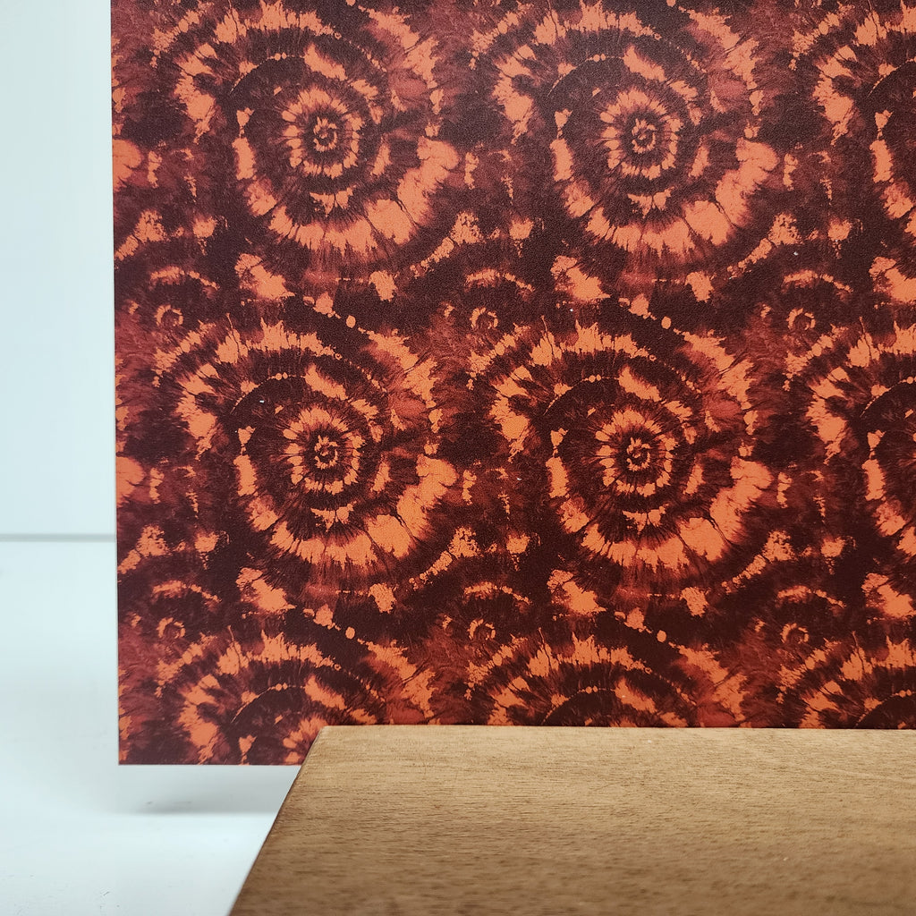 PatternPly® Full Coverage Maroon and Orange Tie Dye sheet showing the pattern
