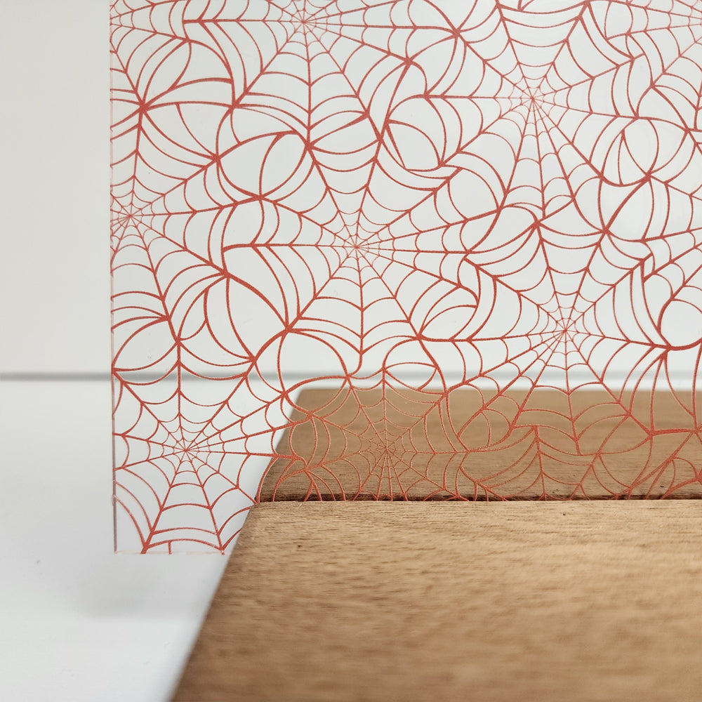 PatternPly® Scattered Vermilion Spiderwebs Mini sheet showing the pattern