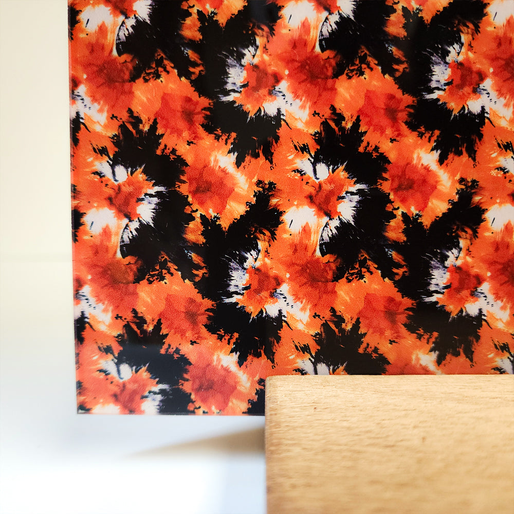 PatternPly® Full Coverage Orange and Black Halloween Tie Dye sheet showing the pattern