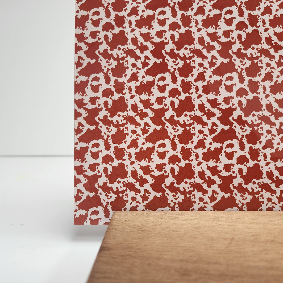 PatternPly® Full Coverage Burnt Orange Cow Spots sheet showing the pattern