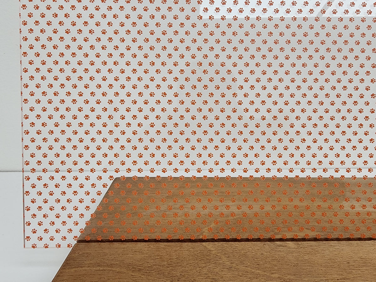 PatternPly® Scattered Micro School Pawprints ORANGE sheet showing the pattern