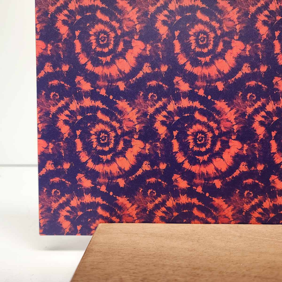 PatternPly® Full Coverage Orange and Purple Tie Dye sheet showing the pattern