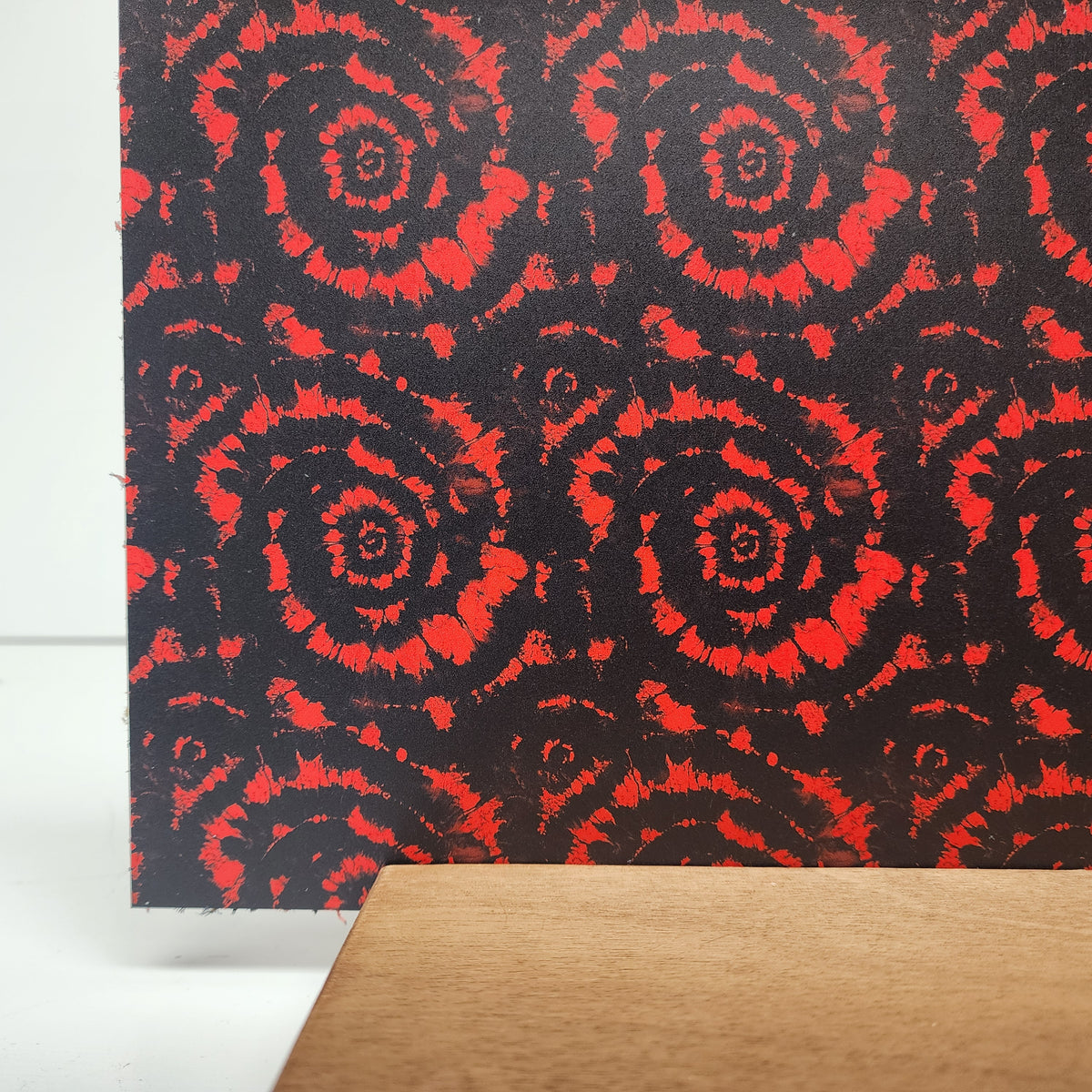PatternPly® Full Coverage Red and Black Tie Dye sheet showing the pattern