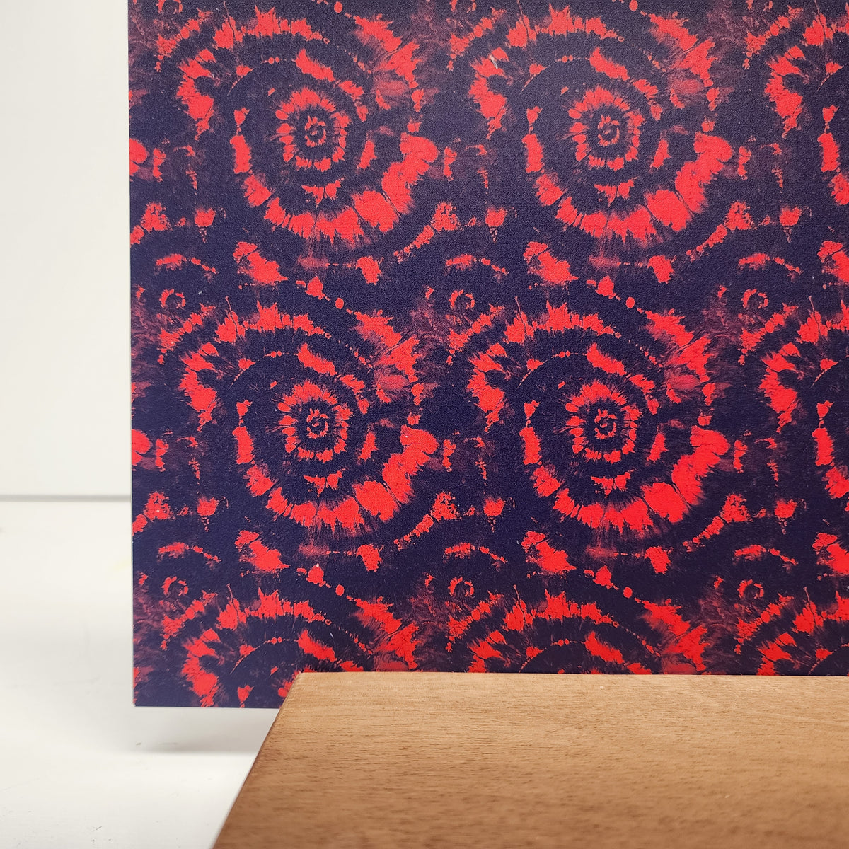 PatternPly® Full Coverage Red and Blue Tie Dye sheet showing the pattern
