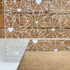 PatternPly® Scattered White Spiderwebs with White Hearts sheet showing the pattern