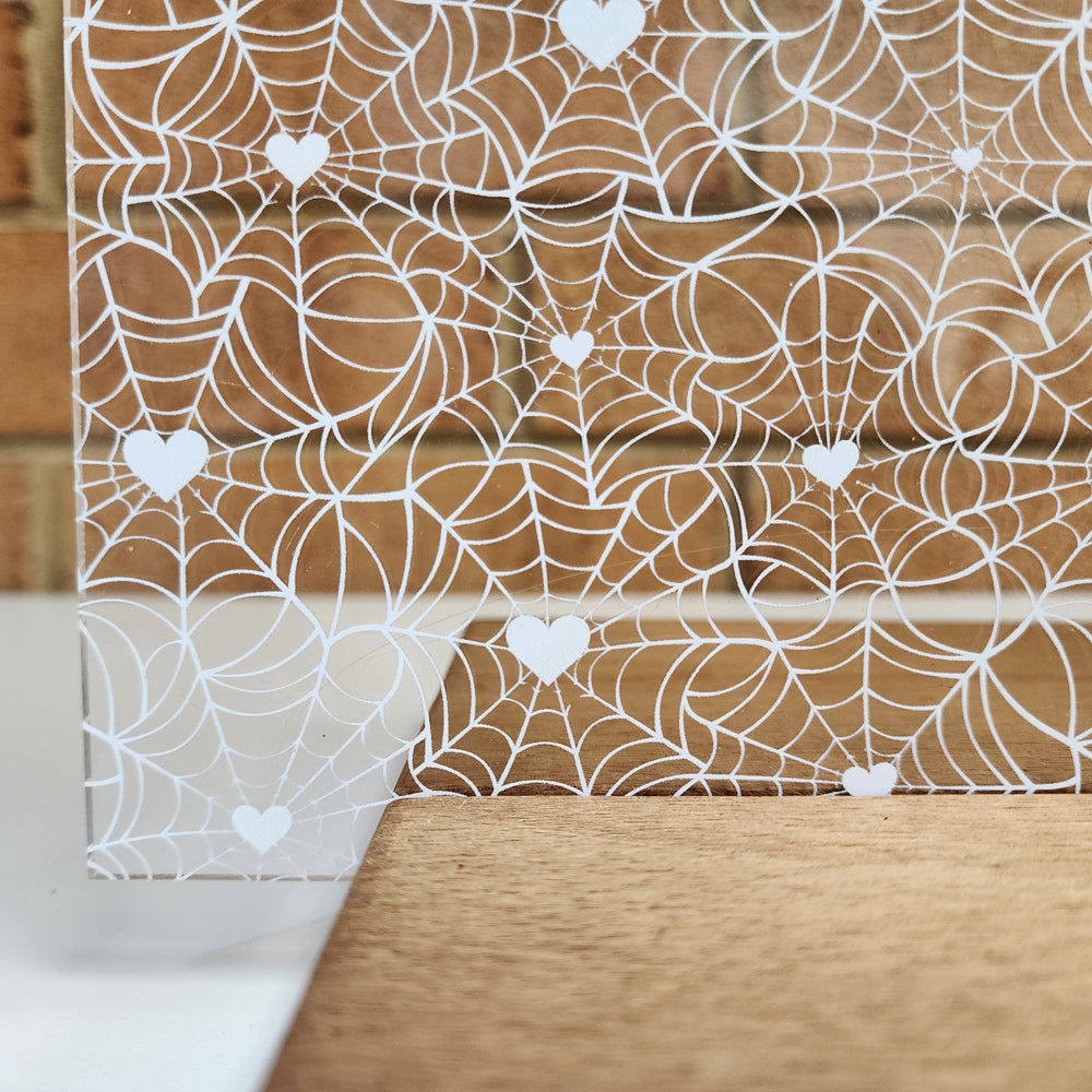 PatternPly® Scattered White Spiderwebs with White Hearts sheet showing the pattern