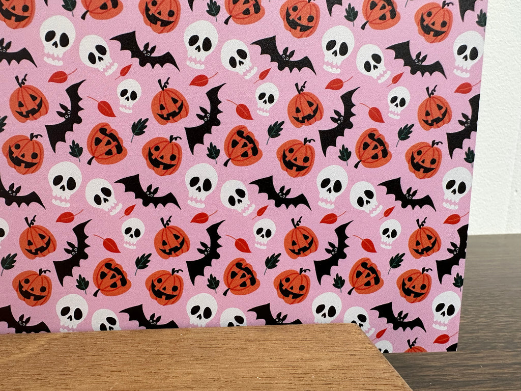 PatternPly® Full Coverage Bats Skulls and Jack o Lanterns on Pink Background sheet showing the pattern