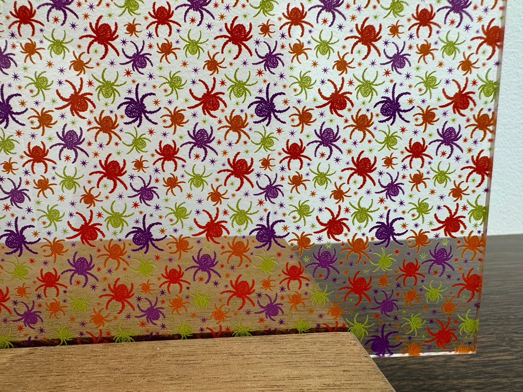PatternPly® Scattered Colorful Spiders sheet showing the pattern