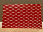 PatternPly® Full Coverage Red and White Paw Prints sheet showing the pattern