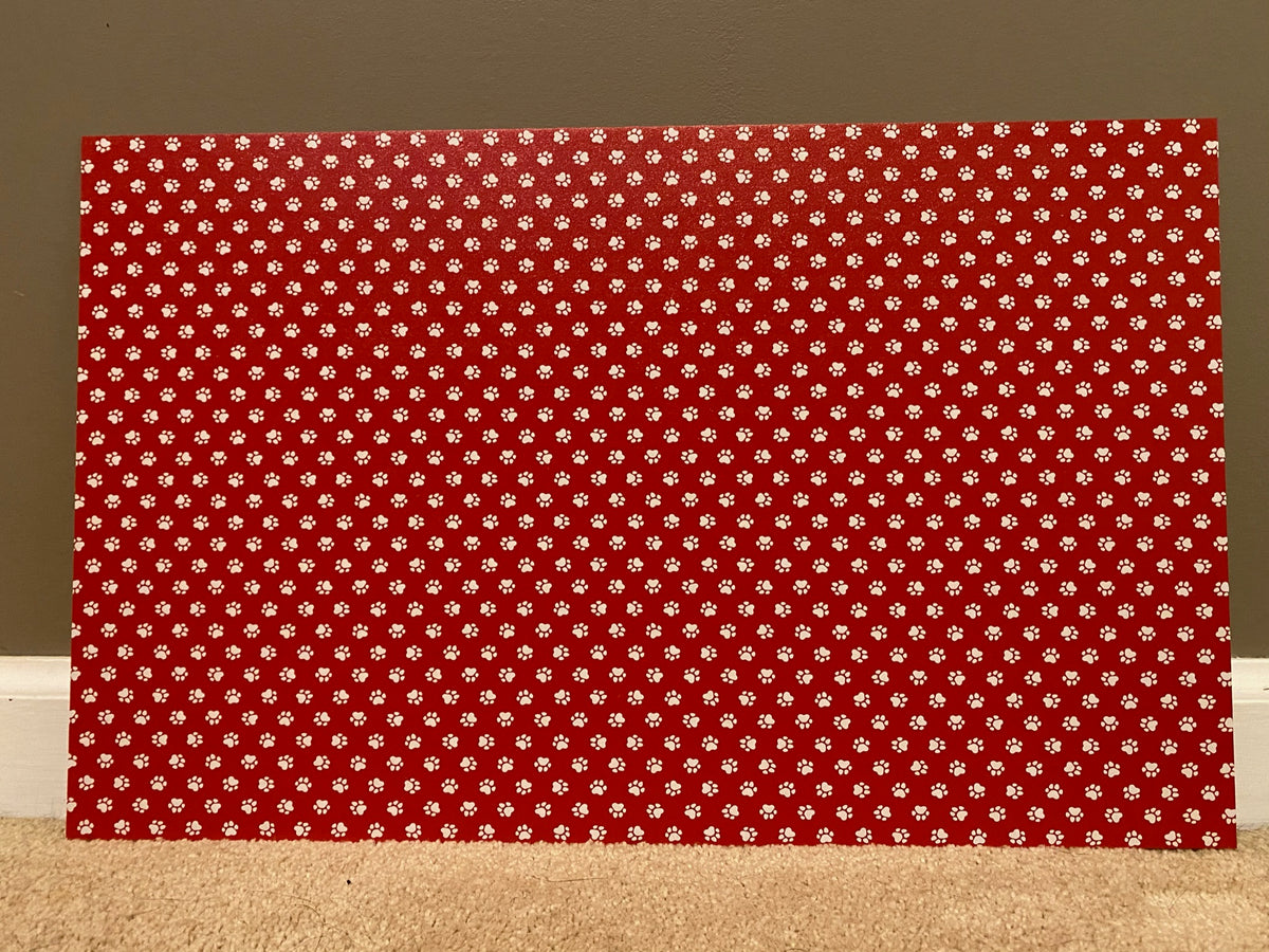 PatternPly® Full Coverage Red and White Paw Prints sheet showing the pattern