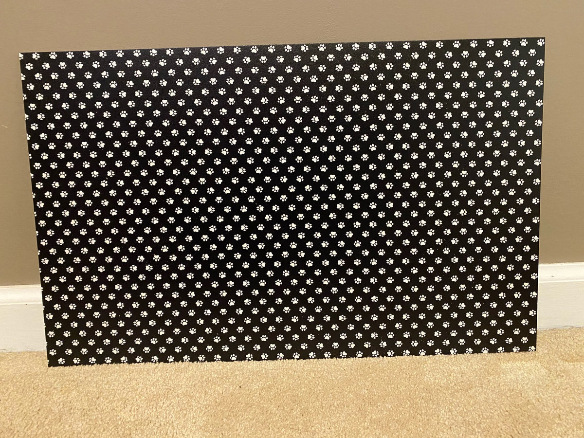 PatternPly® Full Coverage Black and White Paw Prints sheet showing the pattern