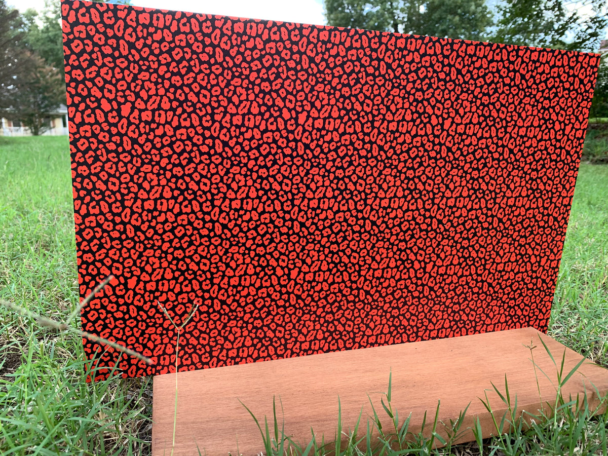 PatternPly® Full Coverage Black and Orange Leopard sheet showing the pattern