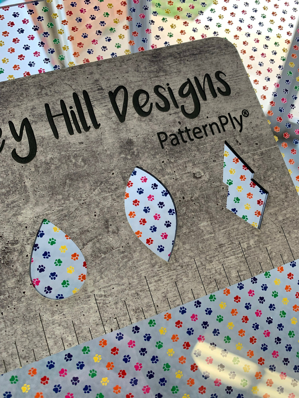 PatternPly® Scattered Micro Rainbow Pawprints sheet showing the pattern