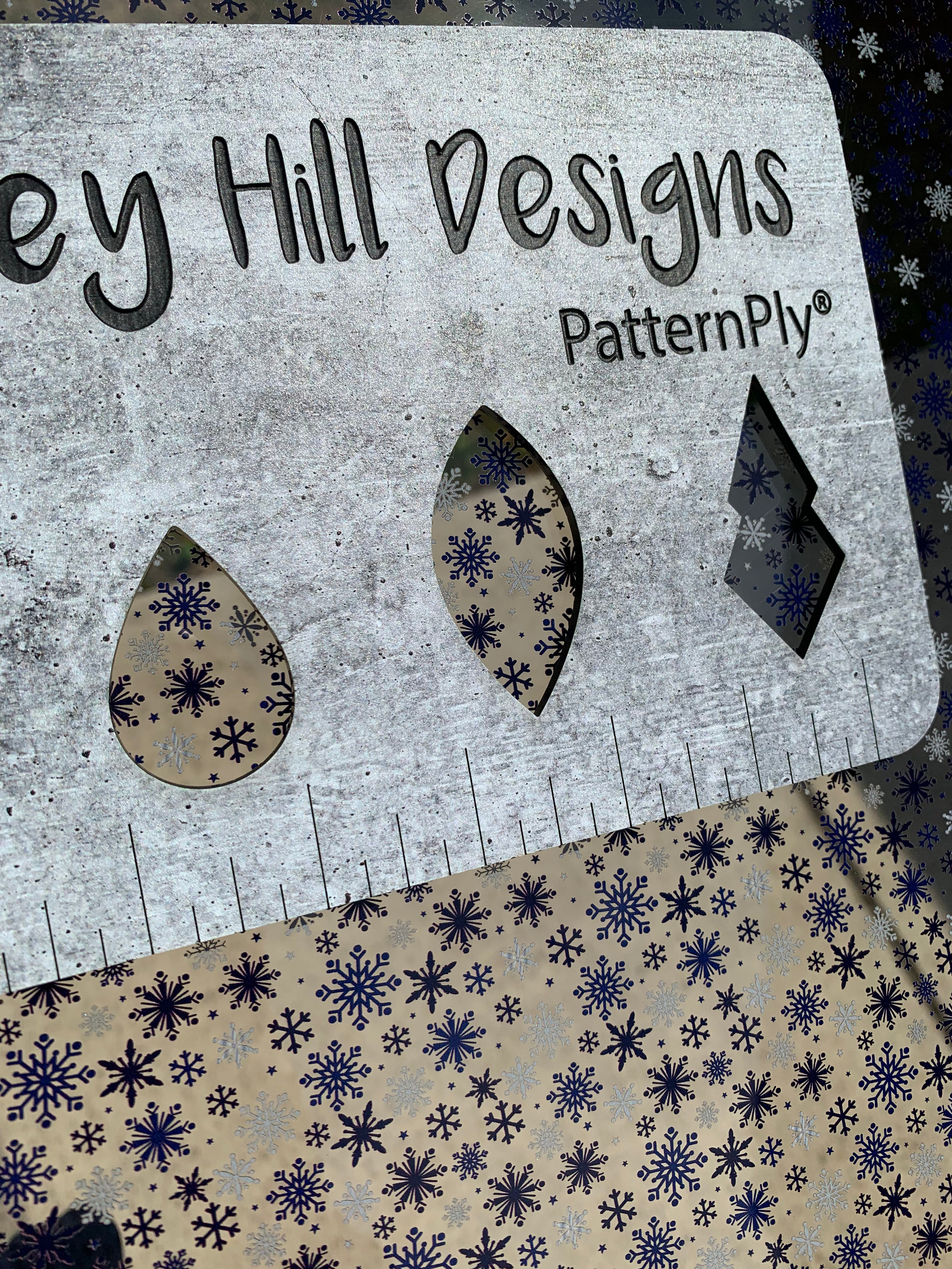 PatternPly® Scattered Navy Blue Snowflakes sheet showing the pattern