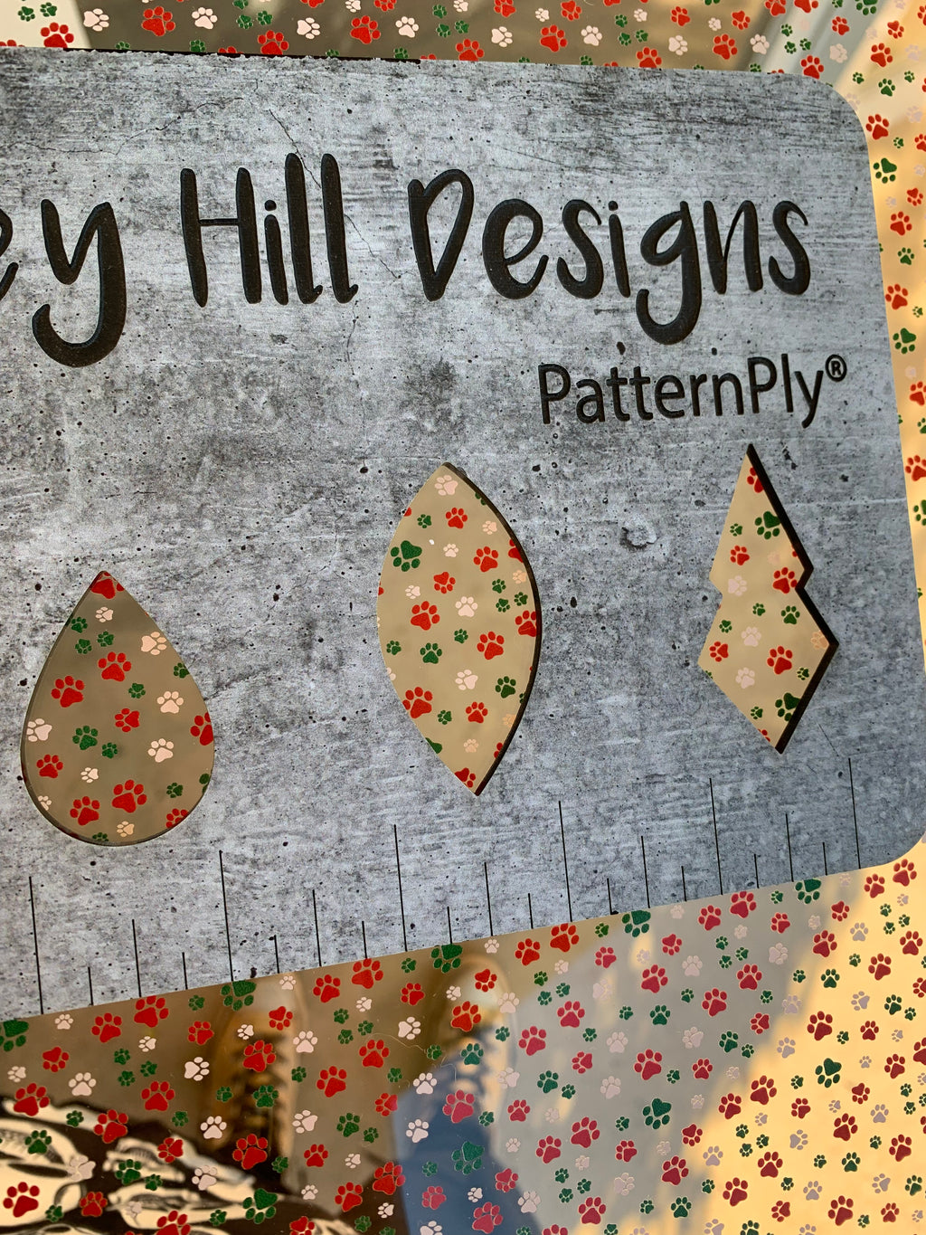 PatternPly® Scattered Red, White, Green Pawprints sheet showing the pattern