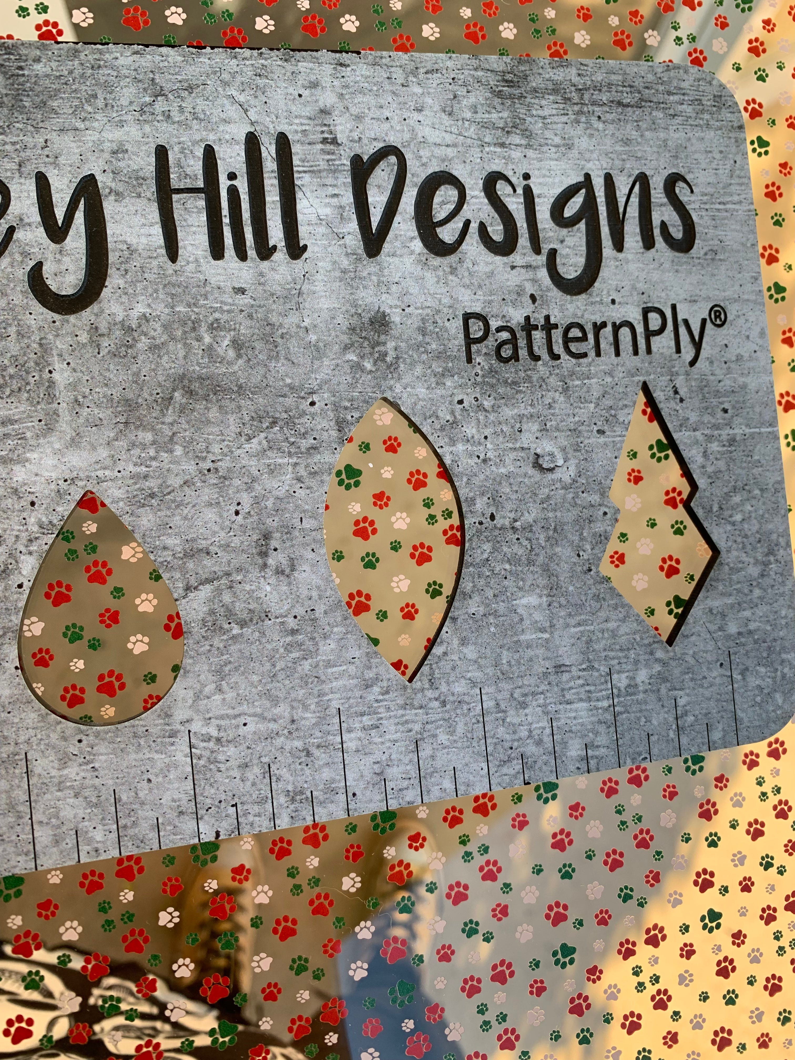 PatternPly® Scattered Red, White, Green Pawprints sheet showing the pattern