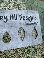 PatternPly® Scattered Green Micro Skull Leopard sheet showing the pattern